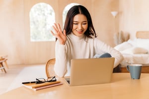 Employee working remotely at home on her laptop