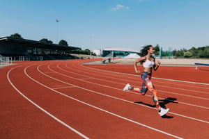 Woman running on a track outside